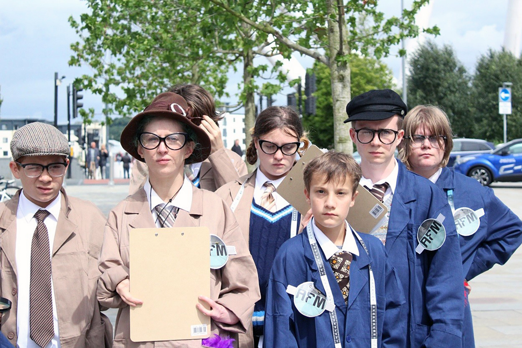 Junior members of the Anti Fun ministry out and about in Newport, wearing regulation brown and blue coats, carrying clipboards