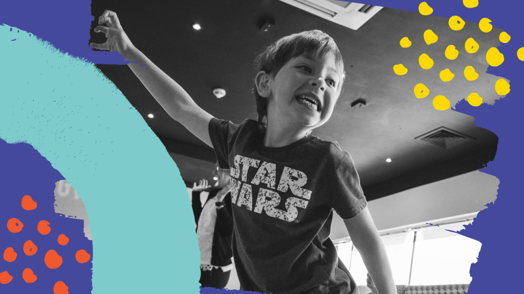 A boy in a Star Wars tshirt poses - he is a lion or a tiger, or even a bear. The photo is surrounded by colourful Taking FLight graphics
